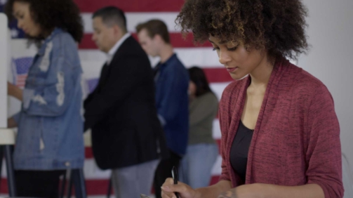 African American women at voting booth on election day