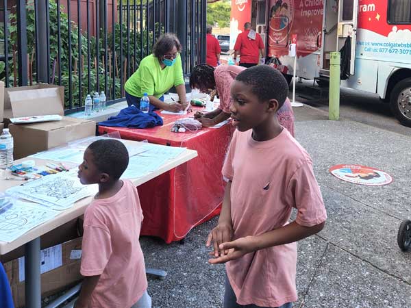 Two children at Colgate Dental Van Initiative with Columbia SC Chapter of The Links, Inc.